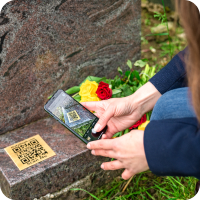 Scanning QR plaque at graveside